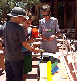 Students testing the temperature of the brick