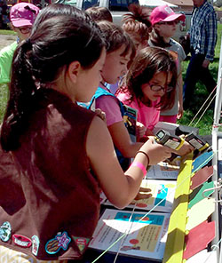 Girl Scouts testing the temperature of the metal cars