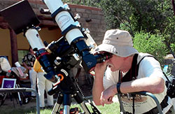 adult looking through a telescope